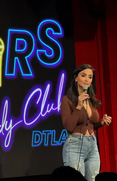 Crystal Marie on stage with a microphone at a Downtown Los Angeles comedy club